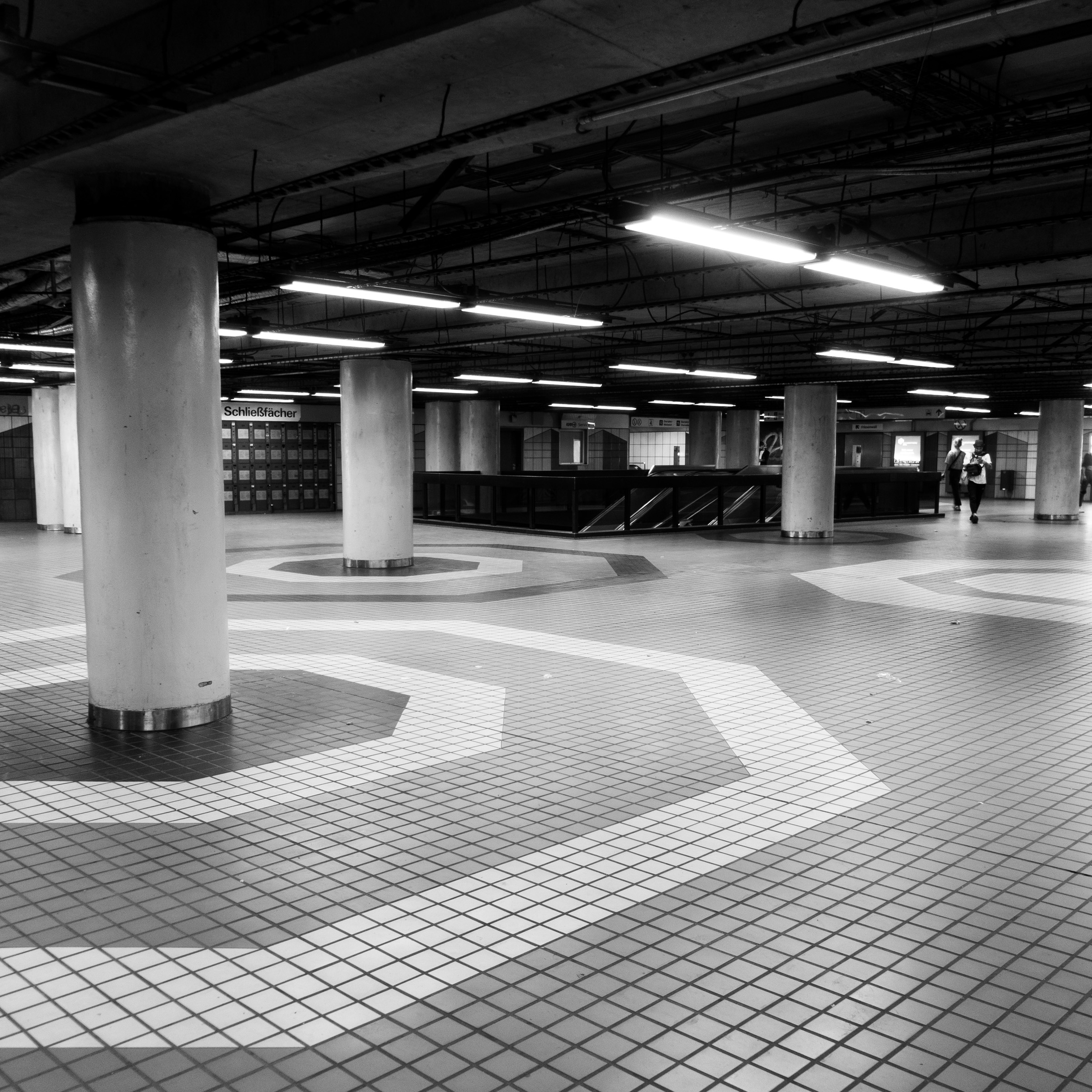 Underground station concourse at Friesenplatz, Cologne, with round columns and patterned tile floor