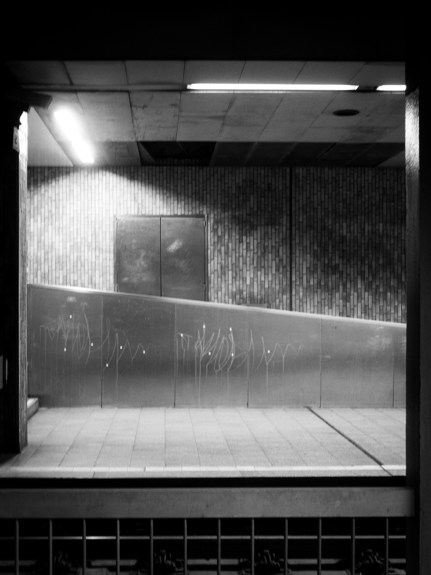 Underpass with a closed steel door and scratched graffiti tags, Lohsestraße, Cologne