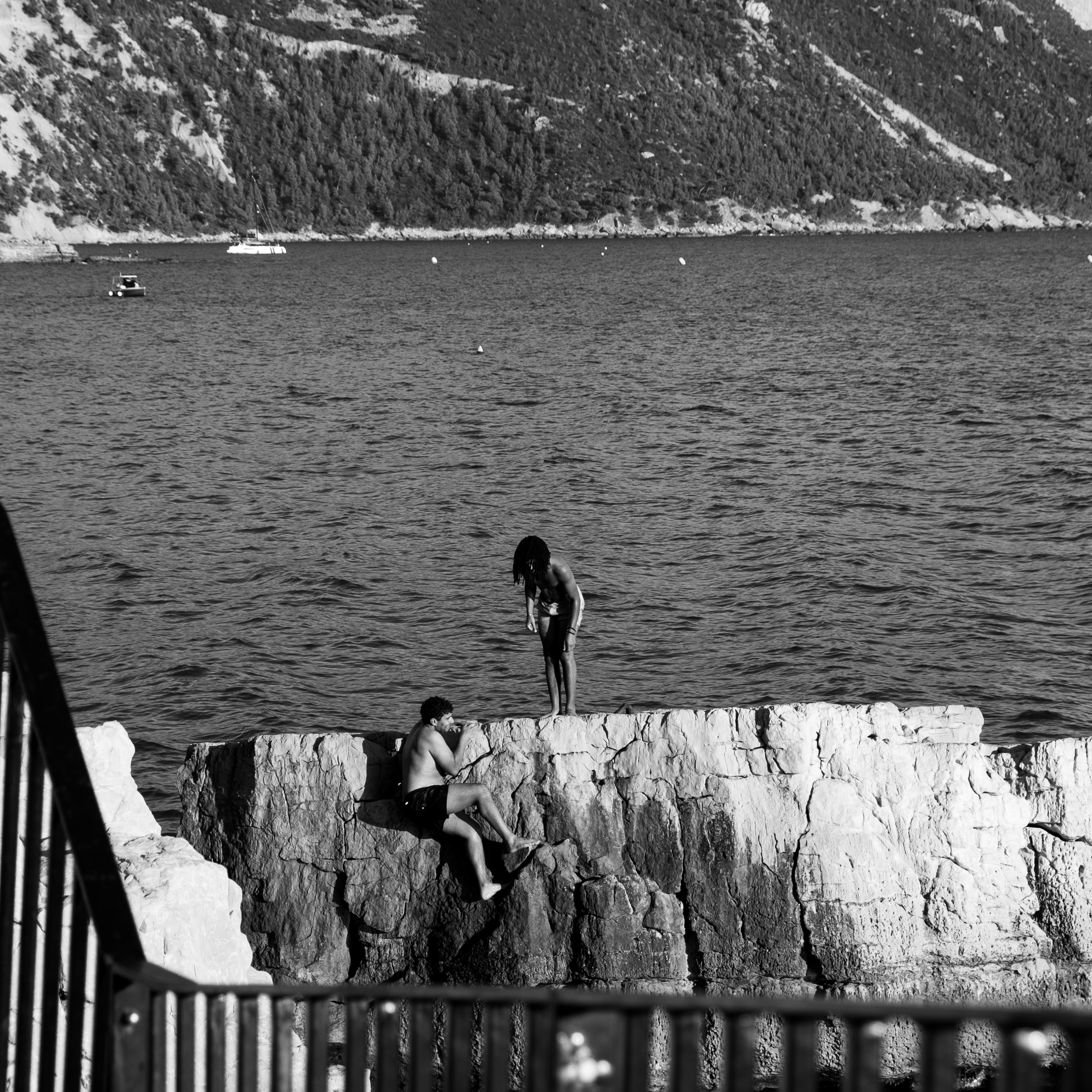 Two people standing on a rock above the sea, Cassis