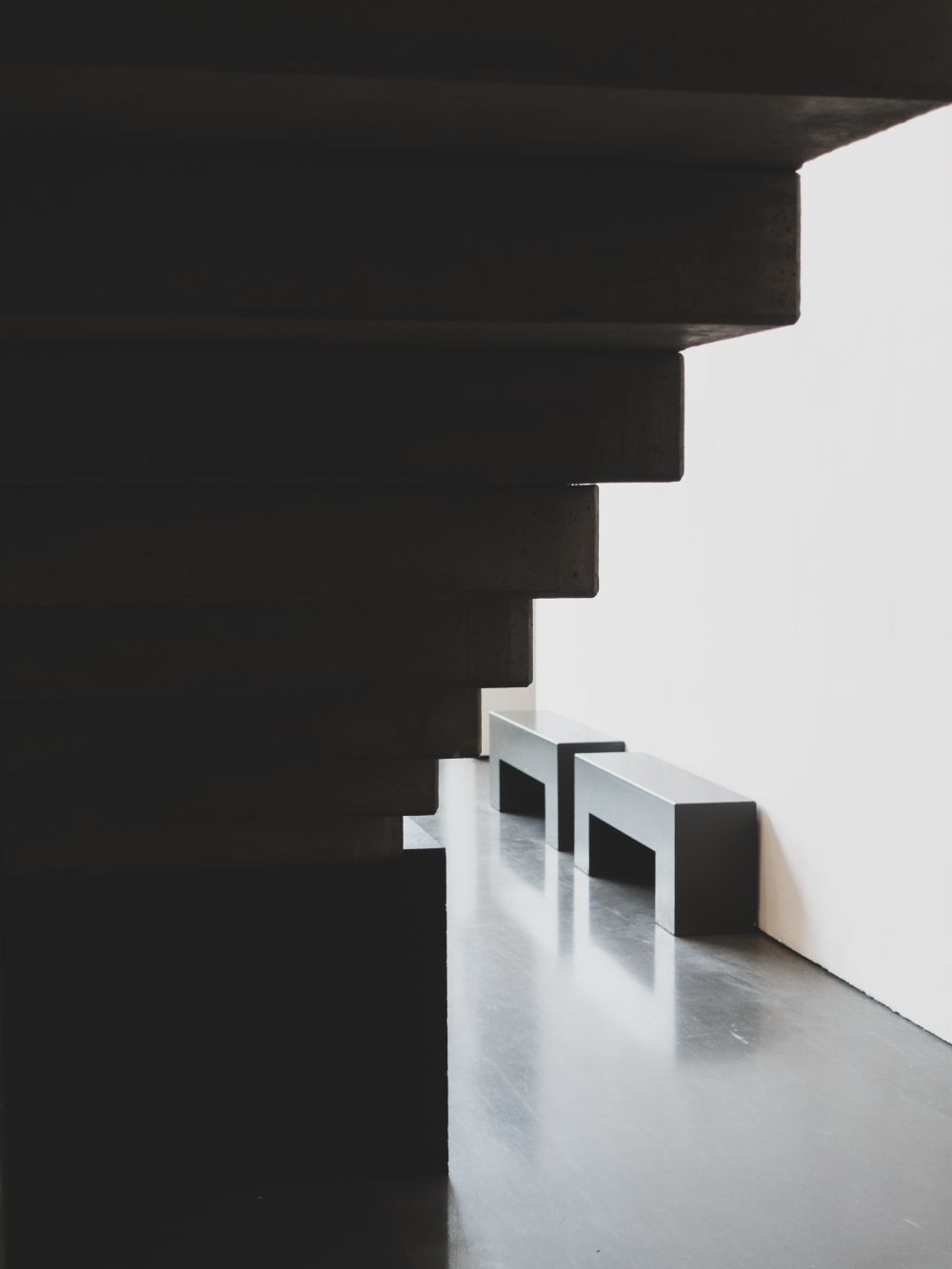 Shadow detail under concrete staircase with benches and doorway, Kunsthalle Düsseldorf