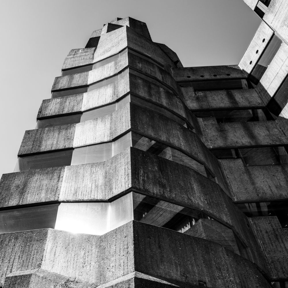 Sunlit upward view of the tower's faceted concrete peak