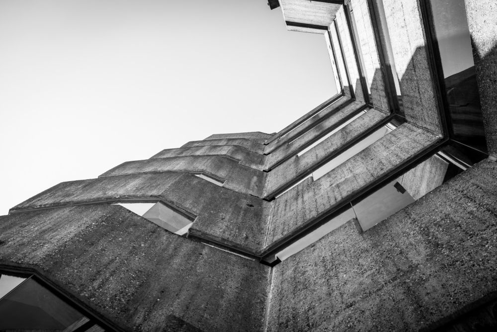 Upward angled view of zigzagging concrete corner elements against the sky