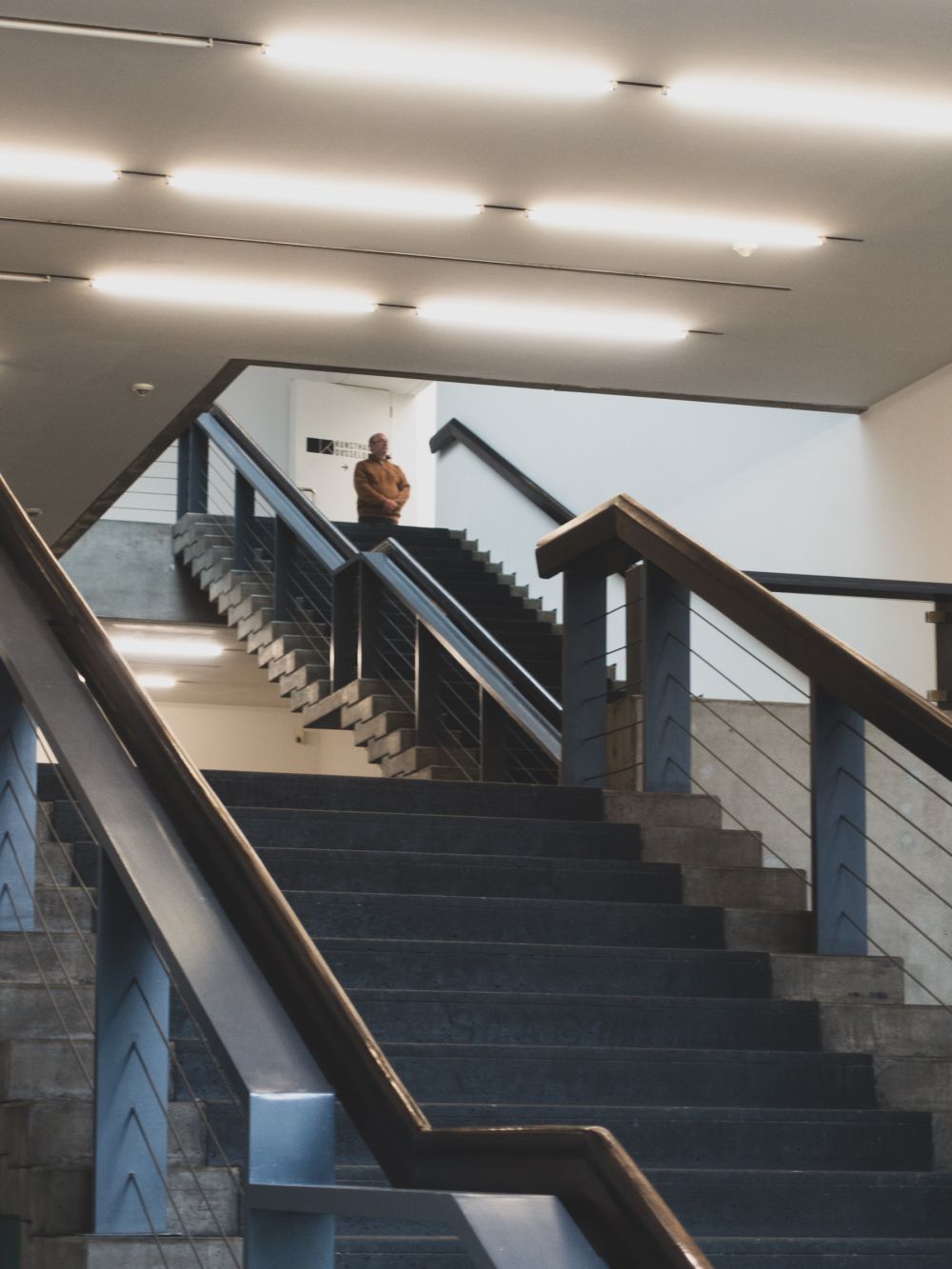 Staircase interior detail with concrete steps and steel railing, Kunsthalle Düsseldorf