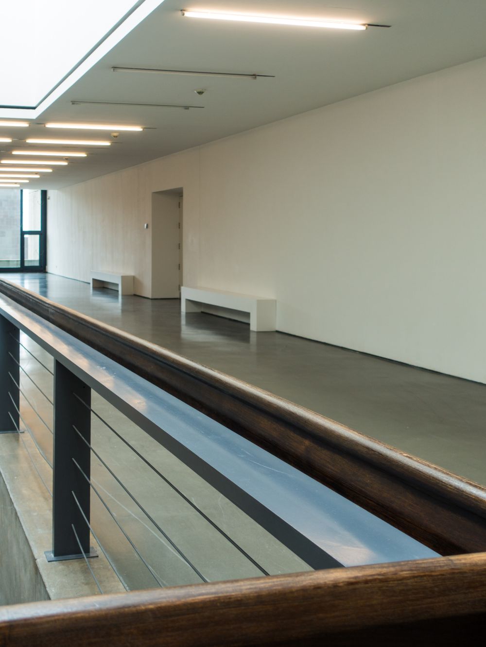 Upper gallery level viewed from wooden handrail, empty exhibition space below, Kunsthalle Düsseldorf