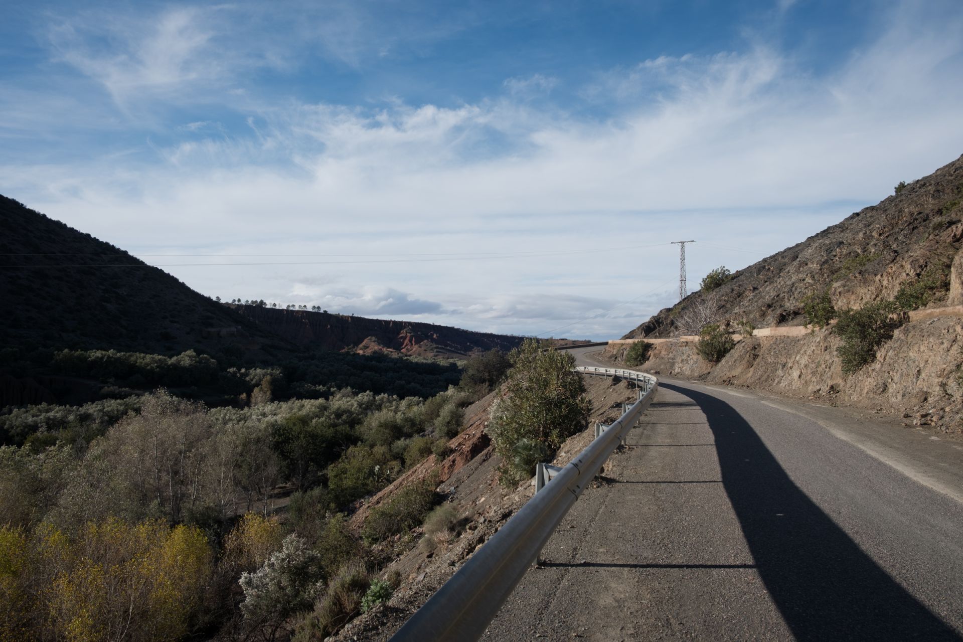 Winding mountain road with a telecommunications tower, illustrating the journey’s remote stretches.