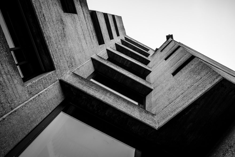 Upward view of Rathaus Bensberg's staggered concrete balconies against the sky